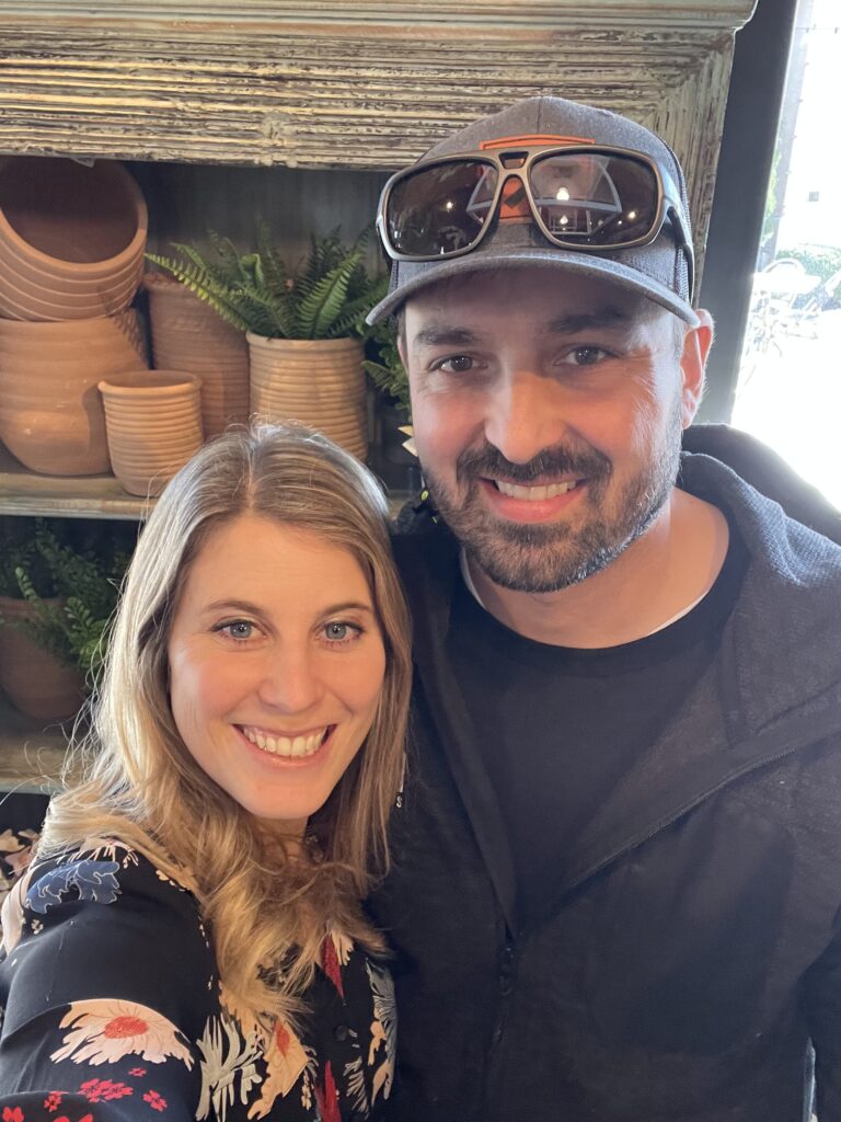 a couple standing together and smiling